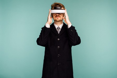 Businessman in a formal wear wearing virtual reality glasses - imageの写真素材
