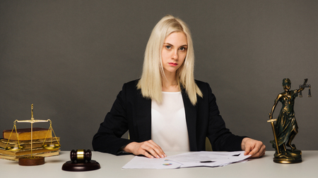Female lawyer working at table in office - imageの写真素材