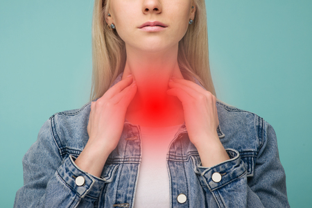 A young girl has a sore throat. Thyroid problems - Imageの写真素材