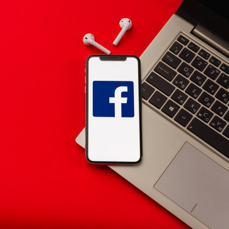 Tula, Russia - May 24,2019: Apple iPhone X with Facrbook logo on the screen on red background. - Imageのeditorial素材