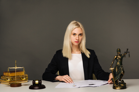 advice and justice concept. Justice scales, justice hammer and Litigation document, female lawyer working legal law with use laptop at lawyer office.の写真素材