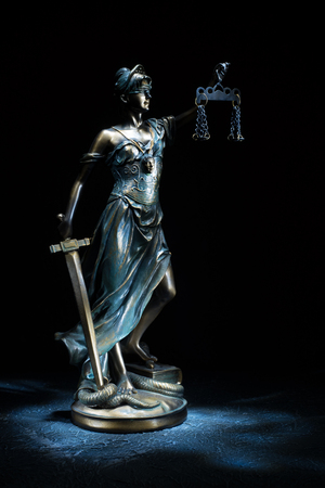 Themis statuette stands on the old vintage stone table. Picture taken with a light brush - Imageの写真素材