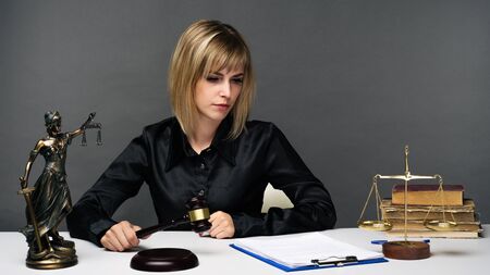 A young fair woman judge works in her office. - imageの写真素材
