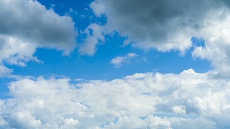 Blue sky background with white fluffy clouds - image