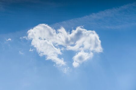 Cloudscape. Blue sky and white heart shaped cloud. Sunny day. - image