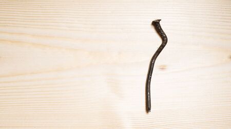 bent nail on a wooden board. Concept stoop, sciatica and degenerative disc disease - image