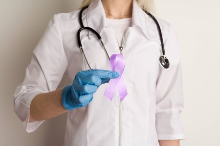 Woman doctor holding a purple ribbon in her hands - imageの写真素材