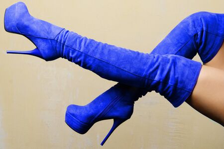 female legs in blue suede high-heeled boots.の写真素材