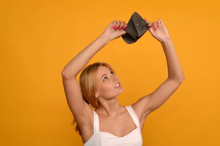 Young woman shows her empty wallet. Bankruptcy - image
