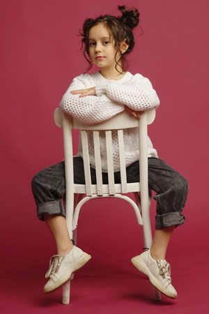 Photo of smiling little girl child isolated over pink background. Looking camera.の写真素材