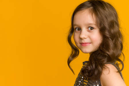 Photo of smiling little girl child isolated over gray background. Looking camera.の写真素材