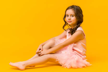 Photo of smiling little girl child isolated over gray background. Looking camera.の写真素材