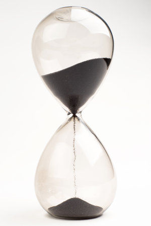 Hourglass as time passing concept for business deadline, urgency and running out of time.