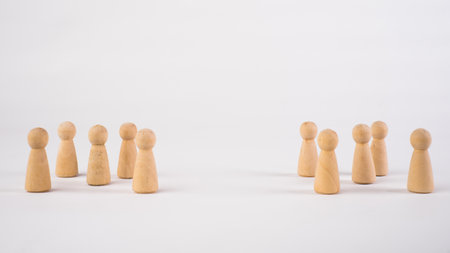 Two different groups of people standing facing to each other for equality and competition in...