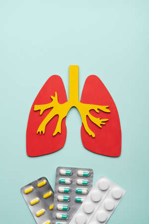 lungs and a pils on a blue background. concept of respiratory disease, pneumonia, tuberculosis,...