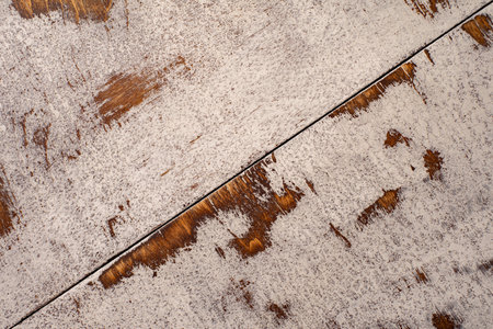 Aged mahogany countertop with cracked and frayed white paintの写真素材