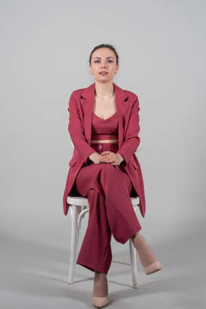 Beautiful young woman businesswoman with soccer ball posing on yellow background? Pointing finger upの写真素材