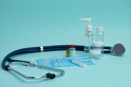 A stethoscope, ampoules, a syringe, a mask and tablets. Medical concept.