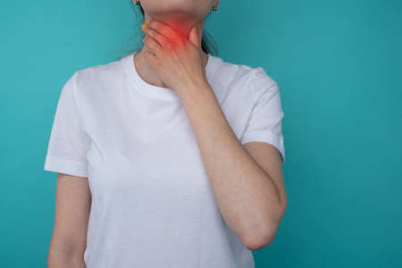Sore Throat. Closeup Of Beautiful Young Woman Hand Touching Her Ill Neck. Healthcare and medical...