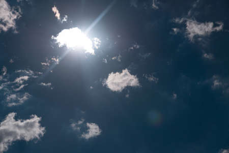 sun shining above beautiful stormy clouds, sky is clearing after rainの写真素材