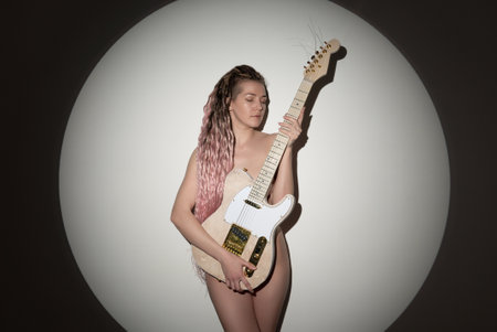 Beautiful young sexy woman with guitar. Musical girl