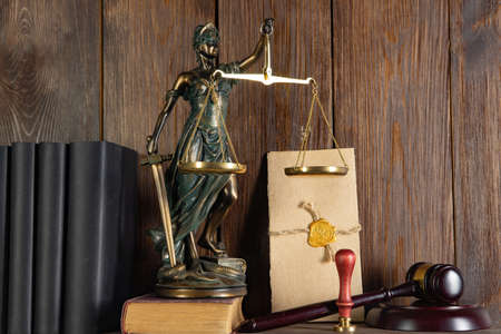 Scales of Justice, Lady Justice, law library concept, Law books in the background.