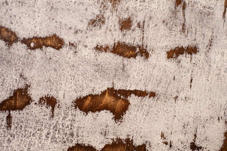Aged mahogany countertop with cracked and frayed white paint