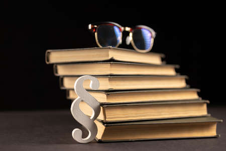 sign paragraph glasses and books on black stone background