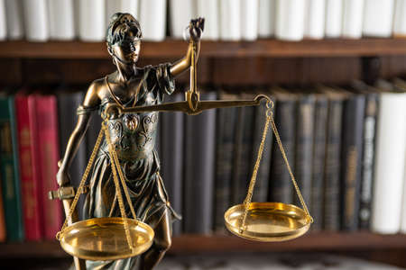 Scales of Justice, Lady Justice, law library concept, Law books in the background.の写真素材