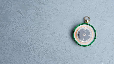 Classic round compass on gray background as symbol of tourism with compass, travel with compass and outdoor activities with compassの写真素材