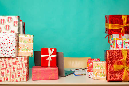 Christmas gifts lie on the table in modern santa's office