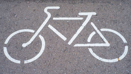 bicycle parking sign painted on the asphalt