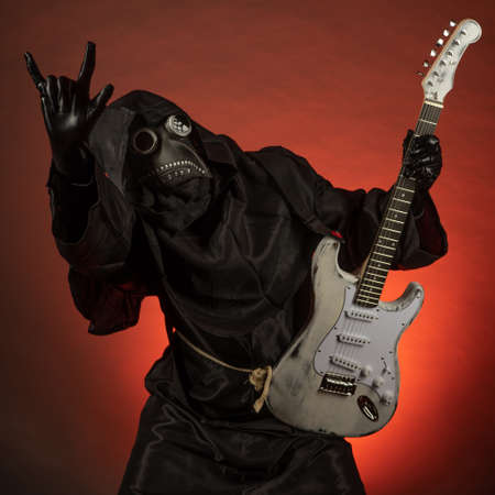Plague doctor with a syringe of medicine or poisonの写真素材