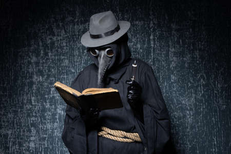 Plague doctor with a syringe of medicine or poison