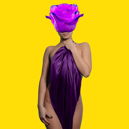 Abstract contemporary art collage beautiful woman in elegant in pink satin with flower rose bud on face on yellow backgroundの写真素材