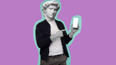 Abstract modern collage. The man with the plaster head of David shows a finger on the smartphone screen on a pink background.の写真素材