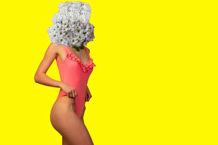 Abstract contemporary art collage young woman standing in bathing suit bikini flower on face. On a yellow backgroundの写真素材