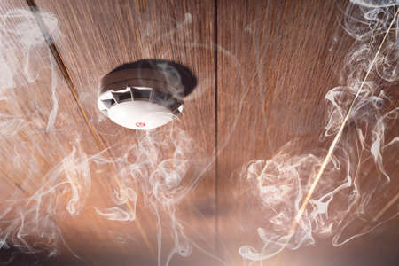 Smoke detector and fire alarm in action background with copy spaceの写真素材