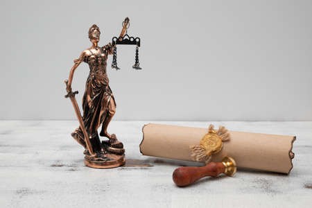 Lady Justice, parchment scroll with seal and stamp on an old wooden table. law and justice concept