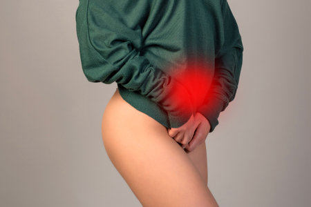 Menstrual pain, woman with stomachache suffering from pms , endometriosis, cystitis and other diseases of the urinary system, painful area highlighted in redの写真素材