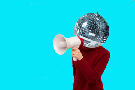 Abstract modern collage. woman with a mirrored disco ball instead of a head holding a megaphone on...
