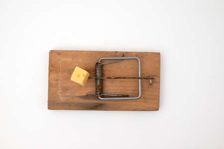 Close up of mouse trap on old wooden table.の写真素材