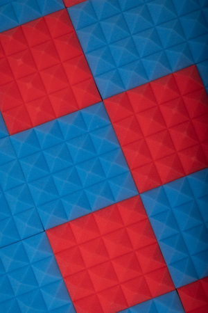 Acoustic foam panel background with red and blue lighting. Music background