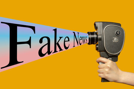 contemporary art collage. Human hand holding movie camera and spreading fake news.の写真素材