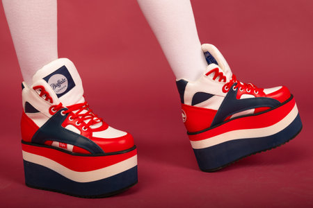 Kyoto city, Japan - May 05, 2023: Woman legs in BUFFALO VEGAN SHOES on red backgroundのeditorial素材