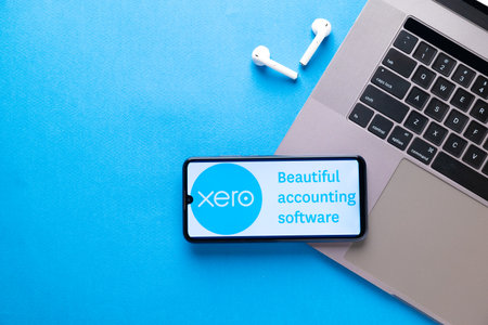 Kyoto city, Japan - July 31, 2023: Xero displayed on a smartphone near modern laptop on blue...