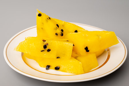 Fresh yellow watermelon slice on background, juicy delicious cut watermelon with a yellow coreの写真素材
