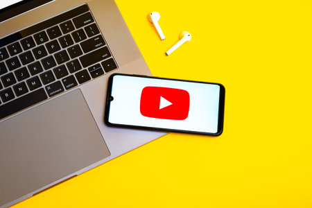 Kyoto city, Japan - July 31, 2023: Apple iPhone with Youtube logo on the screen on yellow backgroundのeditorial素材