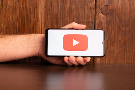 Kyoto city, Japan - July 31, 2023: Apple iPhone with Youtube logo on the screen on wooden backgroundのeditorial素材