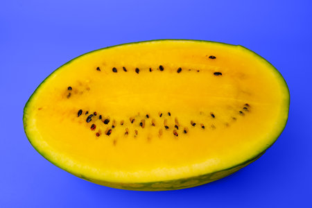 Fresh yellow watermelon slice on background, juicy delicious cut watermelon with a yellow coreの写真素材